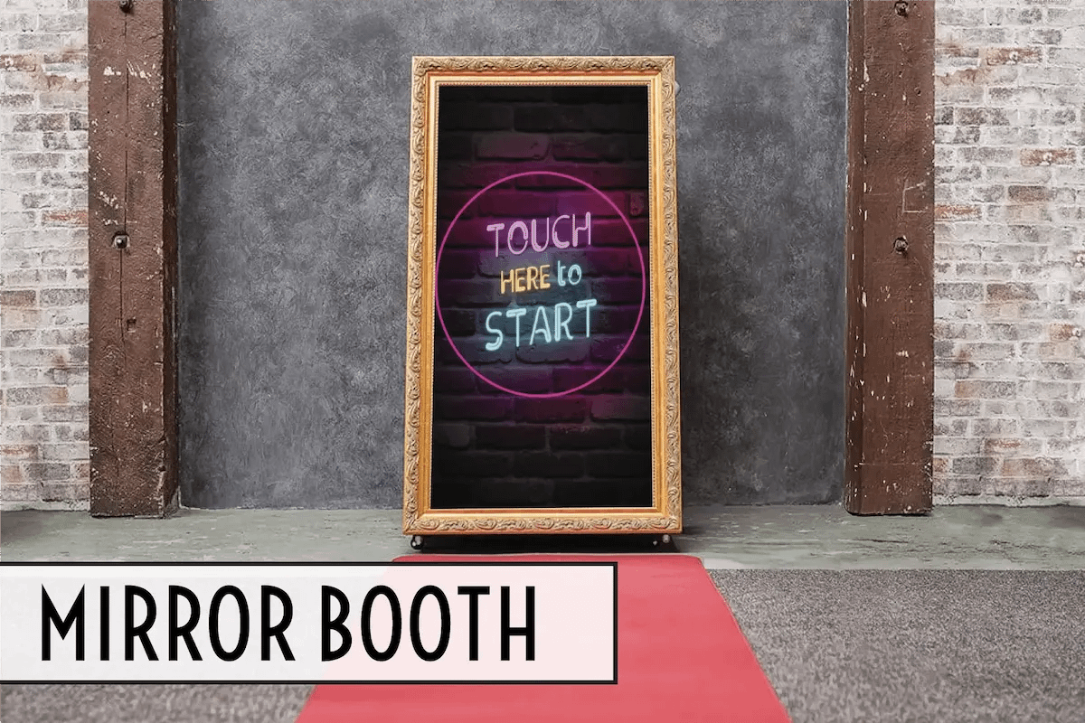 Vintage Mirror Booth displayed on a red carpet against a brick wall
