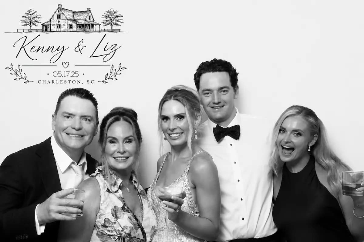 Bride, groom, and family posing in a black-and-white Glam Booth portrait