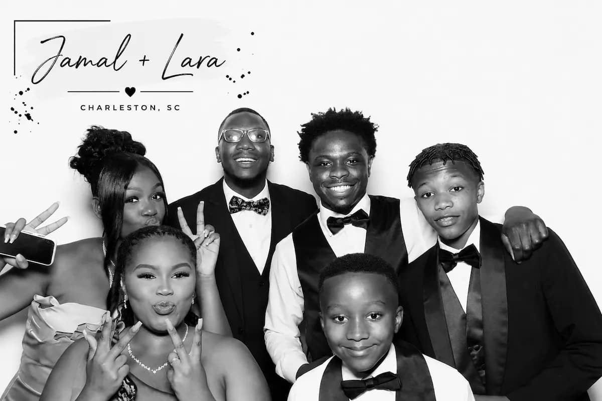 Family dressed for a formal event posing in a black-and-white Glam Booth portrait